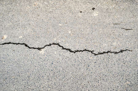 damaged road with cracksの写真素材