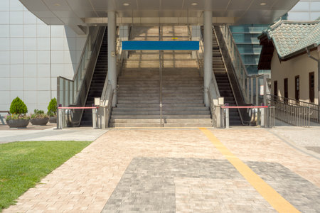 Entrance of modern building with blue signboard in public park, Thailand.の写真素材