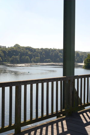 A view of the river Rhine from a wooden bridge in Germanyの写真素材