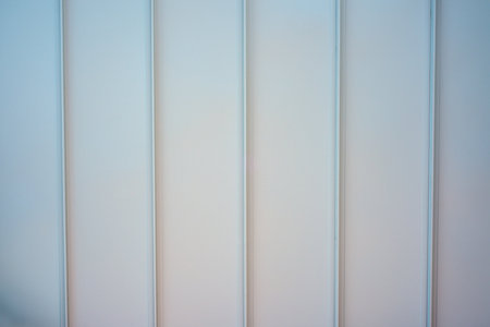 closeup of a white wall with vertical stripes in a modern officeの写真素材