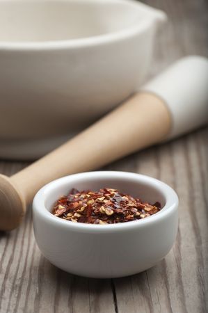Crushed Chillies In A White Dish, With A Mortar and Pestleの写真素材