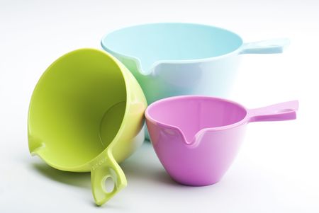 Three Plastic Measuring Cups On A White Backgroundの写真素材