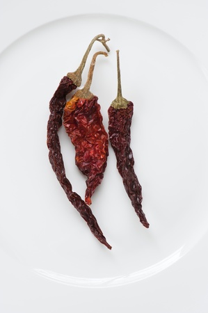 Dried Kashmiri Chillies Laid On A White Plateの写真素材