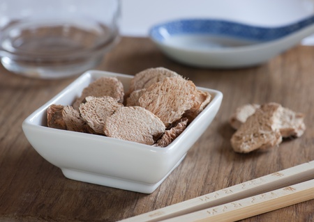 Dish of Dried Galangal Slices, Ready To Be Used For Cooking An Asian meal.の写真素材