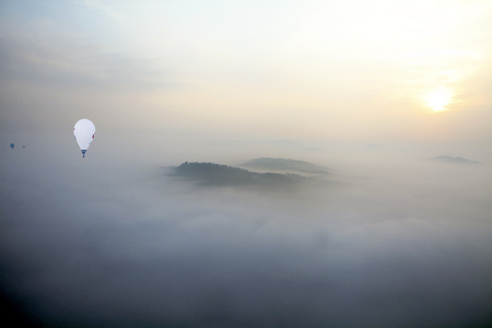 Fly over the clouds with a hot air balloonの写真素材