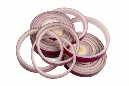 Sliced red onions are arranged in an artistic manner on a white background highlighting their concentric rings and vibrant purple color suggesting freshness and culinary applications.の写真素材