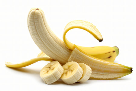 Banana peeled and sliced shows the fruit's texture and freshness against a clean white background perfect for illustrating healthy eating habits and nutritional benefits.の写真素材