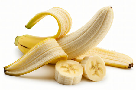 Fresh yellow banana is partially peeled and sliced on a white background ready to be eaten or used in a recipe representing healthy eating and tropical fruit.の写真素材