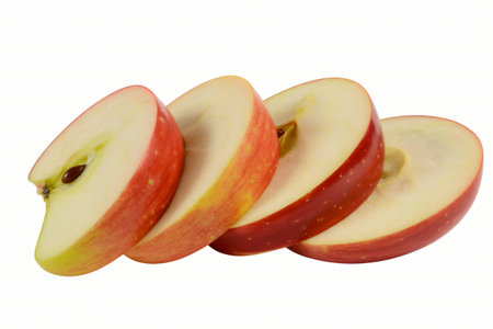 Sliced apples display their crisp texture and vibrant color against a stark white backdrop highlighting freshness and natural goodness perfect for healthy eating and dietary concepts.の写真素材