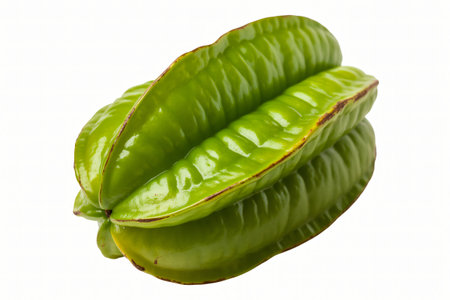 Star fruit displays its vibrant green color and distinctive star shape against a clean white background highlighting its exotic appeal and nutritional benefits for healthy eating.の写真素材