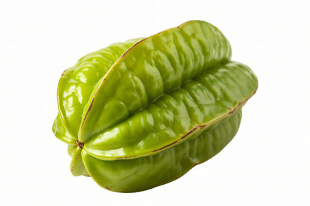 Star fruit displays its vibrant green color and distinctive star shape against a clean white background highlighting its freshness and exotic appeal for healthy eating.の写真素材