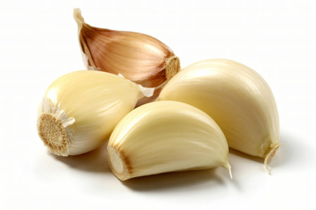 Garlic cloves are displayed on a stark white background showcasing their smooth texture and natural color suggesting freshness and culinary use for adding flavor to various dishes.の写真素材