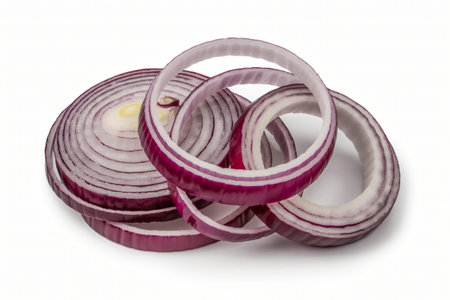 Sliced red onion rings are carefully arranged creating an interesting pattern on a clean white surface showcasing the vegetable's vibrant color and intricate layers perfect for culinary projects.の写真素材