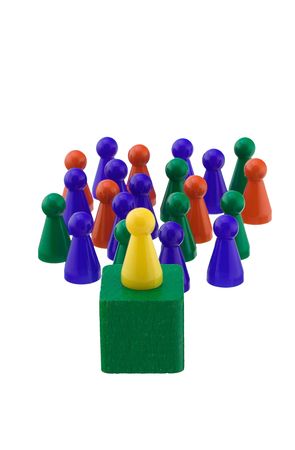Single yellow figure addressing a colorful crowd.の写真素材