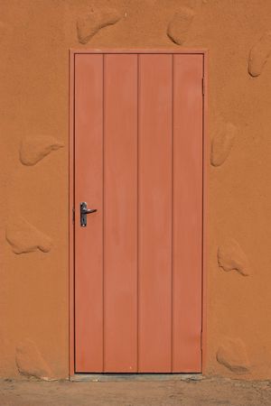 Picture of a closed door and the wall surrounding it.