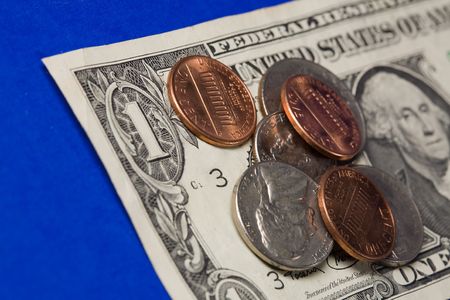 An extreme macro shot of dollar bills and coins.
