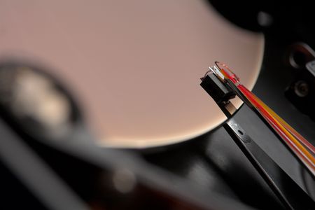 A macro shot of the read and write head of a hard disk.