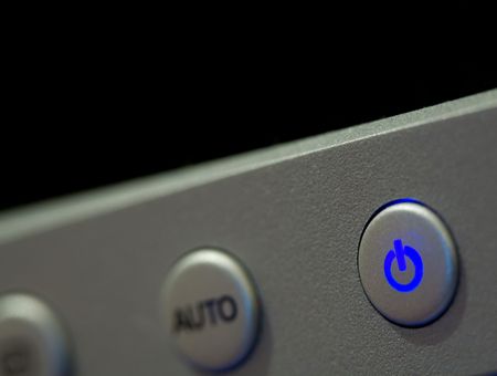 Macro shot of the illuminated on/off switch of a computer display.の写真素材