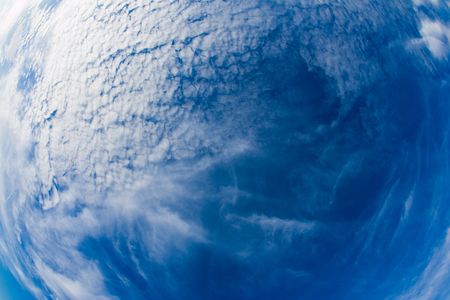 Picture of a beautiful blue sky with scattered clouds.の写真素材