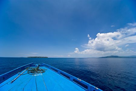 View of a diving boats bow against a blue sky with beautiful cloudscape.の写真素材