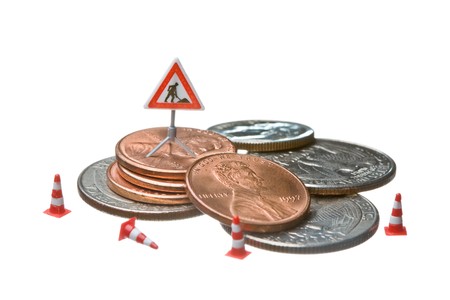 Miniature figures working on a heap of Dollar coins. The objects are isolated on white, a clipping...