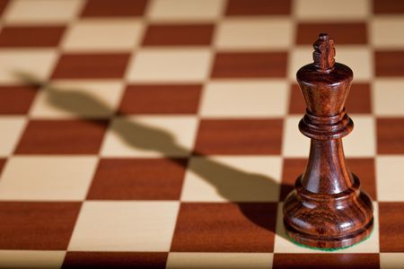 Chess piece - a black king on a chessboard.の写真素材