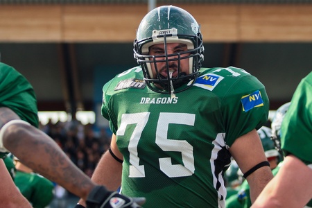 Korneuburg, AUSTRIA - April 18: Austrian Football League:  Uras Aslan (#75, Dragons) and his team win 57:30 against the Vienna Vikings on April 18, 2009 in Korneuburg, Austria.のeditorial素材