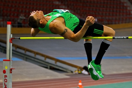 VIENNA, AUSTRIA - FEBRUARY 19: Indoor track and field championship. Roland Schwarzl (#348, Austria) places ninth in the men's high jump event event on February 19, 2011 in Vienna, Austria.のeditorial素材