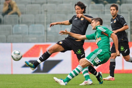 VIENNA,  AUSTRIA - JULY 26  Daniel Parejo Munoz (#18, Valencia) and Deni Alar (#33, Rapid) fight for the ball during the friendly soccer game on July 26, 2011 in Vienna, Austria. SK Rapid wins 4:1.のeditorial素材
