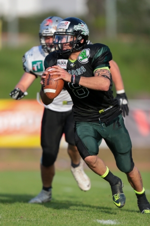 VIENNA,  AUSTRIA - JUNE 8 QB Jonathan Dally (#8 Dragons) runs with the ball during the AFL football game on June 8, 2013 in Vienna, Austria.のeditorial素材