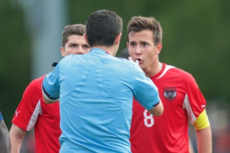 TRAISKIRCHEN, AUSTRIA - JUNE 10 Marcel Sabitzer (#10 Austria) and Christian Gartner (#8 Austria) argue with referee Stavros Tritsonis (Greece) during the U19 game on June 10, 2013 in Traiskirchen, Austria.のeditorial素材