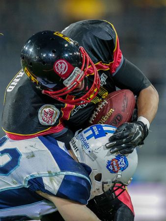 ST. POELTEN, AUSTRIA - MAY 30, 2014: WR Joseph Joyner (#9 Germany) is tackled by an opponent.のeditorial素材