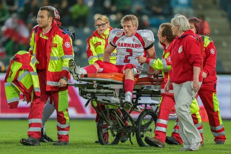 GRAZ, AUSTRIA - MAY 31, 2014: LB Timmi Kleinnibbelink Rysgaard (#2 Denmark) is transported off the field after an injury.のeditorial素材