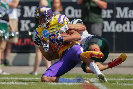 VIENNA, AUSTRIA - JUNE 22, 2014: WR Laurinho Walch (#6 Vikings) is tackled by S Sascha Verhoeven (#3 Dragons).のeditorial素材