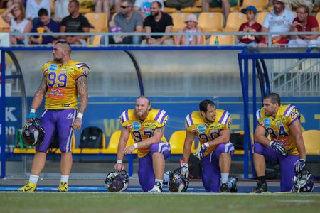 VIENNA, AUSTRIA - JUNE 22, 2014: DL Harald Zipfelmayer (#99 Vikings) and his team mates stand on the sideline during the game.のeditorial素材