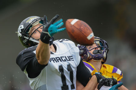 VIENNA, AUSTRIA - JULY 13, 2014: WR Jan Dundacek (#11 Panthers) reaches for the ball during an Austrian football league game.のeditorial素材