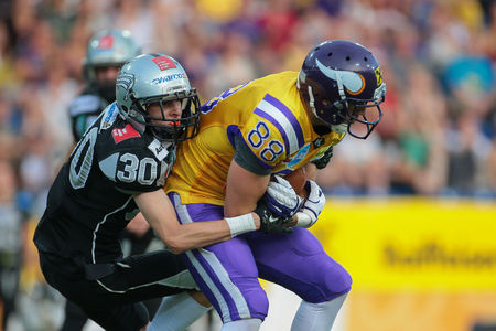 ST. POELTEN, AUSTRIA - JULY 26, 2014: DB Alexander Achammer (#30 Raiders) tackles WR Stefan Postel (#88 Vikings) during Austrian Bowl XXX.のeditorial素材