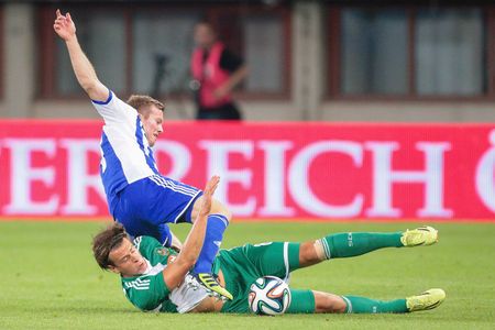 VIENNA, AUSTRIA - AUGUST 28, 2014: Sebastian Sorsa (#27 Helsinki) and Stefan Schwab (#8 Rapid) fight for the ball in an UEFA Europa League qualifying game.のeditorial素材