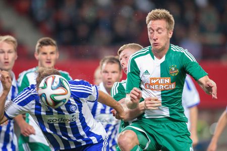 VIENNA, AUSTRIA - AUGUST 28, 2014: Markus Heikkinen (#6 Helsinki) and Robert Beric (#9 Rapid) fight for the ball in an UEFA Europa League qualifying game.のeditorial素材