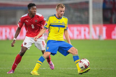 VIENNA, AUSTRIA - SEPTEMBER 9, 2014: David Alaba (#8 Austria) and Sebastian Larsson (#7 Sweden) fight for the ball in an European Championship qualifying game.のeditorial素材