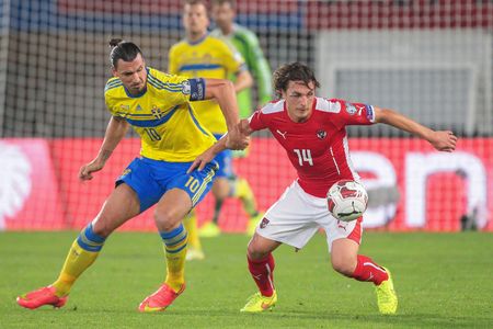 VIENNA, AUSTRIA - SEPTEMBER 9, 2014: Julian Baumgartlinger (#14 Austria) and Zlatan Ibrahimovic (#10 Sweden) fight for the ball in an European Championship qualifying game.のeditorial素材