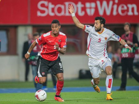 VIENNA, AUSTRIA - OCTOBER 12, 2014: Marko Basa (#5 Montenegro) and Rubin Okotie (#9 Austria) fight for the ball in an European Championship qualifying game.のeditorial素材