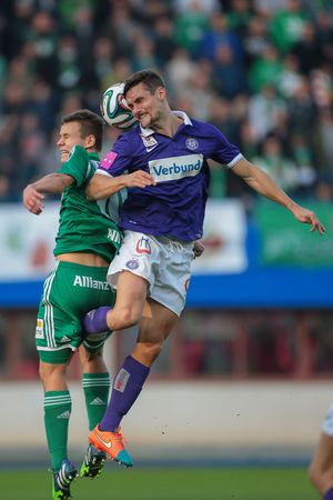 VIENNA, AUSTRIA - NOVEMBER 9, 2014: James Holland (#25 Austria) and Louis Schaub (#10 Rapid) fight for the ball in an Austrian soccer league game.のeditorial素材