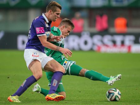 VIENNA, AUSTRIA - NOVEMBER 9, 2014: Alexander GrÃ¼nwald (#10 Austria) and Domink Starkl (#34 Rapid) fight for the ball in an Austrian soccer league game.のeditorial素材
