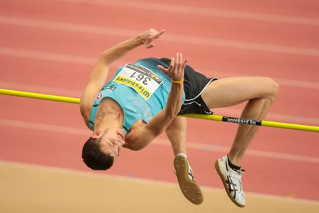 LINZ, AUSTRIA - FEBRUARY 22, 2015: Josip Kopic (#361 Austria) competes in the men's high jump event...