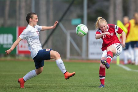 LINDABRUNN, AUSTRIA - APRIL 13, 2015: Siw Doevle (#10 Norway) and Anne Katrine Hansen (#17 Denmark) the ball during a UEFA women's U17 qualifying game.のeditorial素材