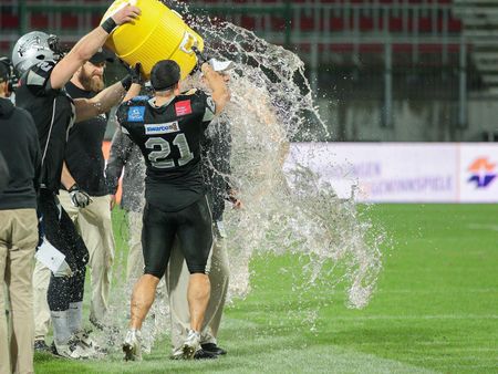 KLAGENFURT, AUSTRIA - JULY 11, 2015: Head Coach Shuan Fatah gets a Gatorade shower after a game of the Austrian Football League.のeditorial素材