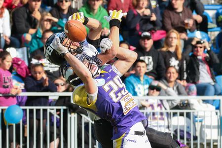 VIENNA, AUSTRIA - JUNE 20, 2015: DB Andreas Lunzer (#29 Vikings) tackles WR Jakub Wolesky (#2 Panthers)  in a game of the Austrian Football League.のeditorial素材