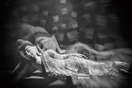 Antique carved wooden Buddha, reclining Buddha posture. selective focus.の写真素材