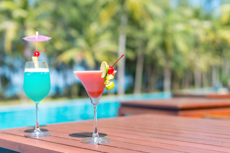 Cocktail glasses at pool, beach side.